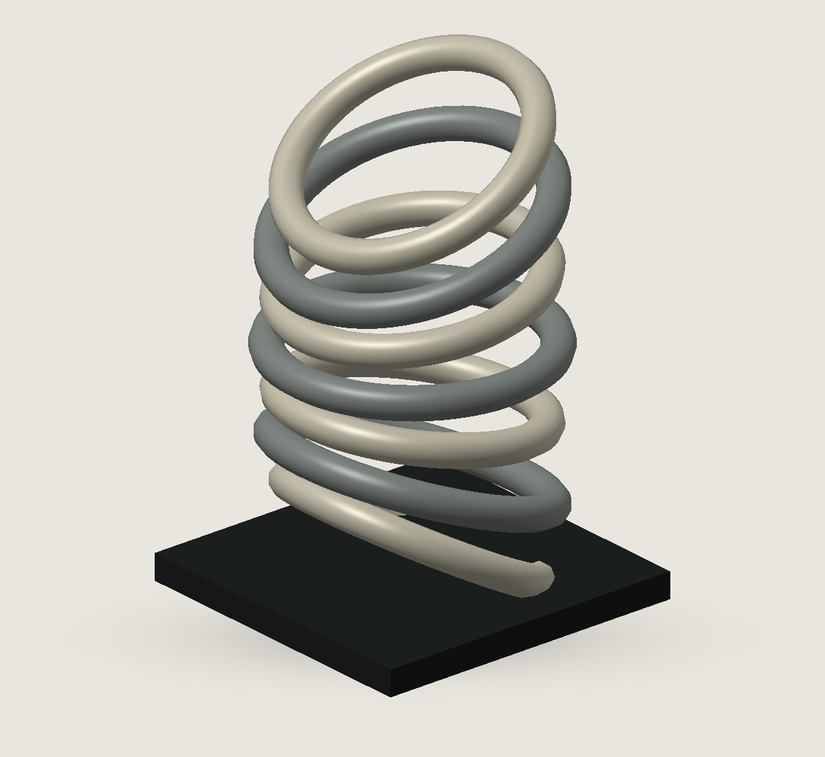 Een sculpturale stapeling van groene en metalen ringen op een donkere vierkante voet. Alternatief standpunt en materiaal.